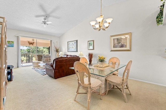 carpeted dining area with a textured ceiling, high vaulted ceiling, and ceiling fan with notable chandelier