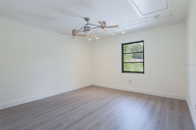 empty room with ceiling fan, hardwood / wood-style floors, and ornamental molding