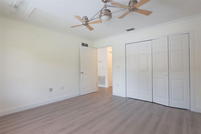 unfurnished bedroom featuring a closet, ceiling fan, light hardwood / wood-style flooring, and ornamental molding