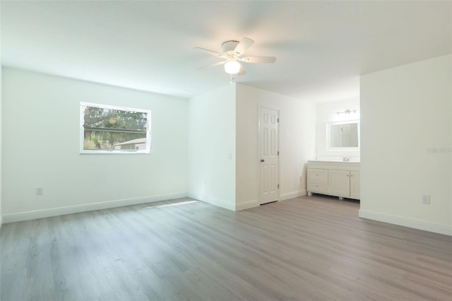 unfurnished room with ceiling fan and light hardwood / wood-style flooring