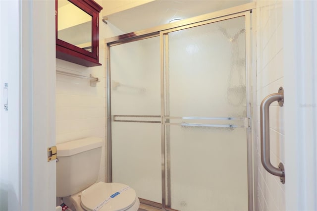 bathroom with toilet and walk in shower