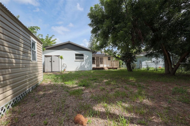 view of yard with a shed and a deck