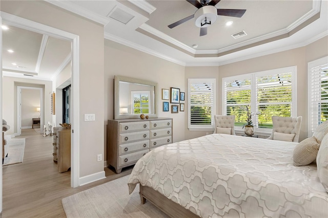 bedroom with light hardwood / wood-style floors, ornamental molding, a raised ceiling, and ceiling fan