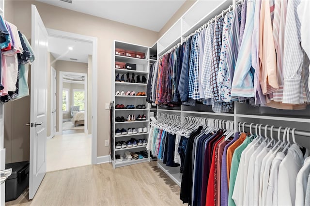 spacious closet with wood-type flooring and radiator heating unit