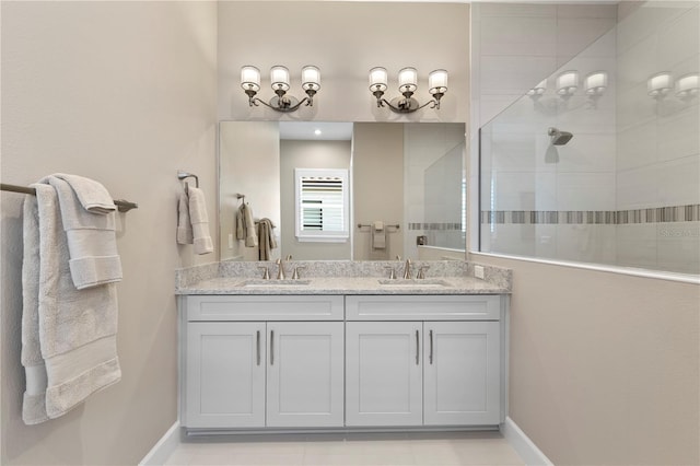 bathroom with a tile shower and vanity