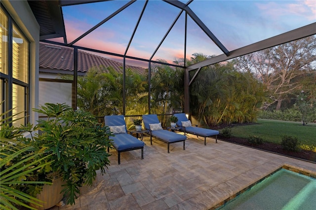 patio terrace at dusk featuring glass enclosure