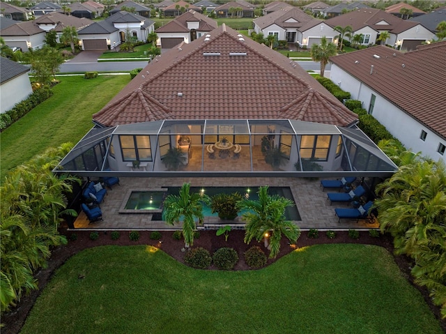 back of house with a yard, a lanai, and a patio