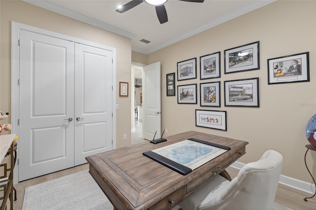 office space featuring crown molding, light hardwood / wood-style flooring, and ceiling fan