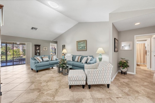 tiled living room with lofted ceiling and a textured ceiling