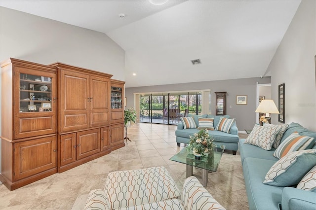 tiled living room featuring vaulted ceiling