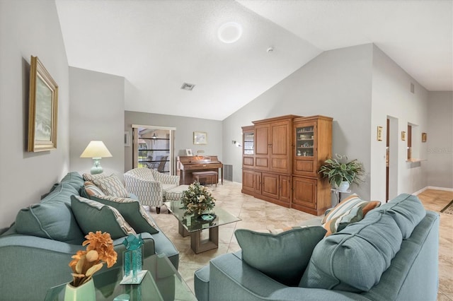 living room featuring high vaulted ceiling