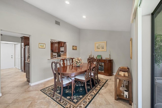 dining space with vaulted ceiling