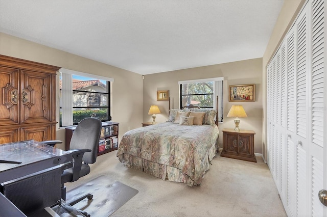 carpeted bedroom featuring a closet and a textured ceiling