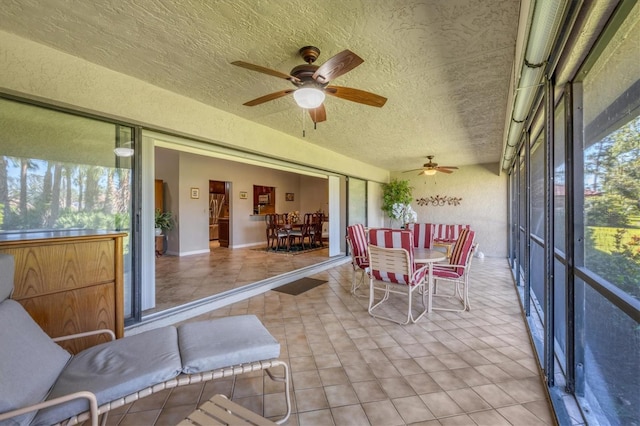 sunroom featuring ceiling fan