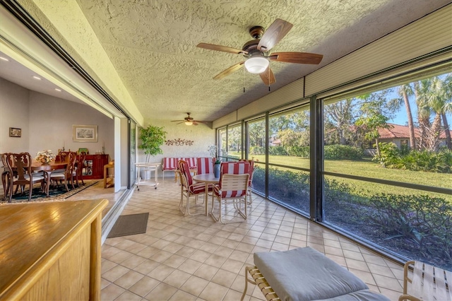 sunroom featuring ceiling fan