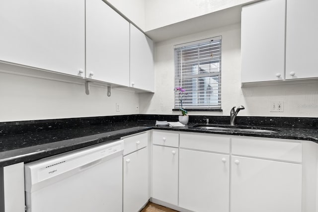 kitchen with white dishwasher, white cabinetry, and sink