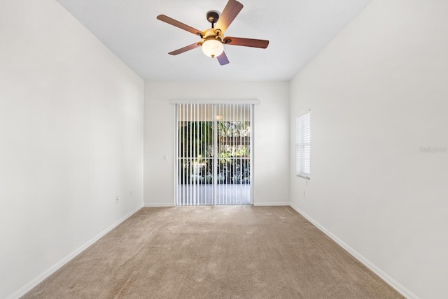 carpeted spare room with ceiling fan