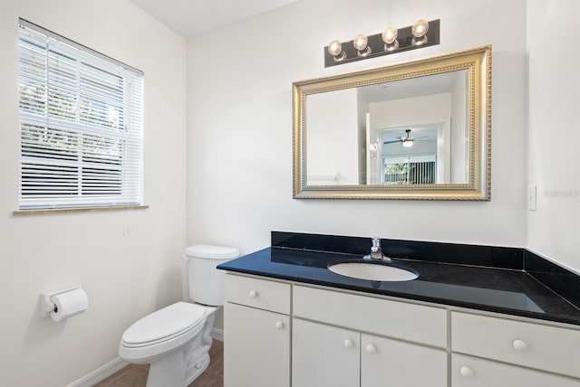 bathroom featuring vanity, toilet, and ceiling fan