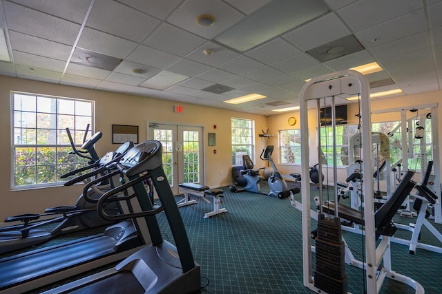 workout area featuring carpet flooring, a paneled ceiling, and french doors