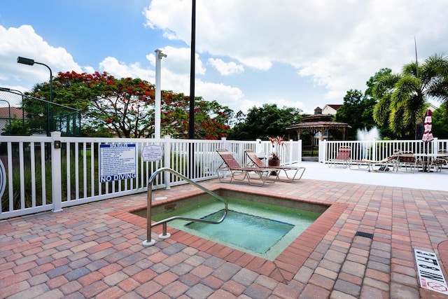 view of pool with a gazebo and a community hot tub