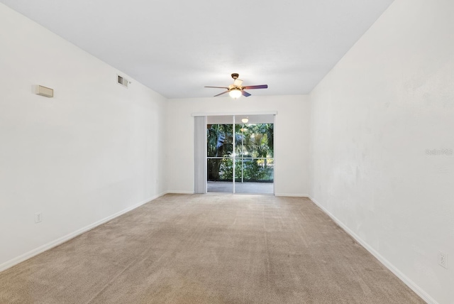 unfurnished room with light colored carpet and ceiling fan