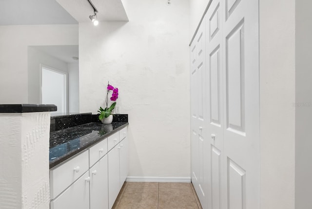 bathroom featuring vanity, rail lighting, and tile patterned floors