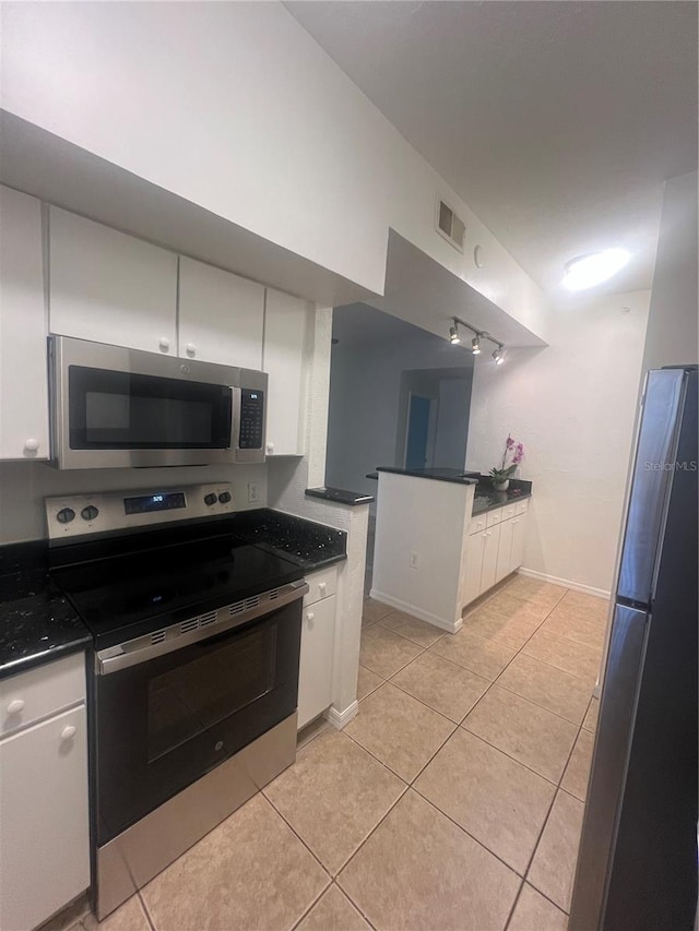 kitchen featuring white cabinets, appliances with stainless steel finishes, and light tile patterned floors