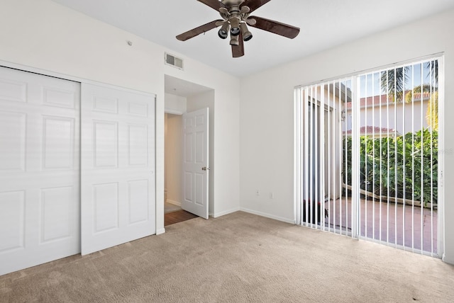 unfurnished bedroom featuring carpet, access to outside, a closet, and ceiling fan