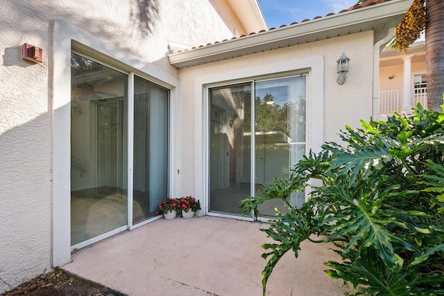 property entrance featuring a patio area