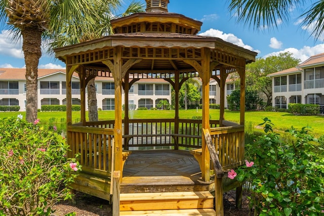 wooden deck with a gazebo and a yard