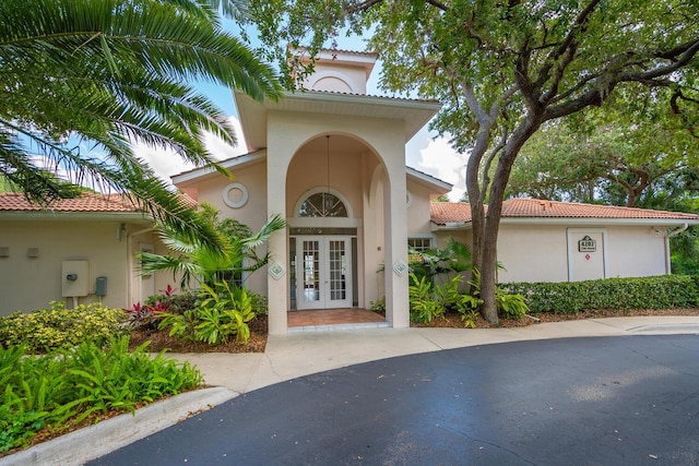 view of exterior entry featuring french doors