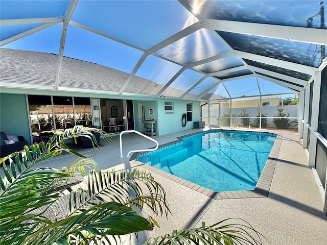 view of swimming pool with a patio area and a lanai