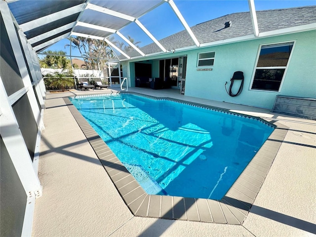 view of swimming pool with a patio and glass enclosure