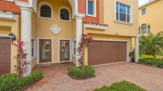 doorway to property with a garage