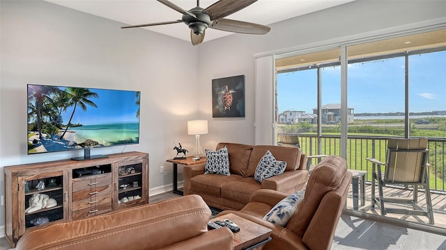 living room with hardwood / wood-style floors, ceiling fan, and a healthy amount of sunlight