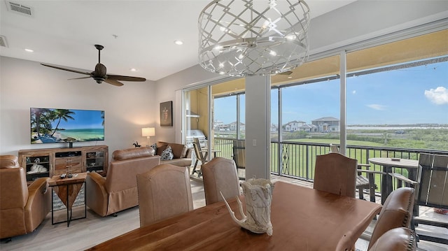 dining room with light wood-type flooring and ceiling fan