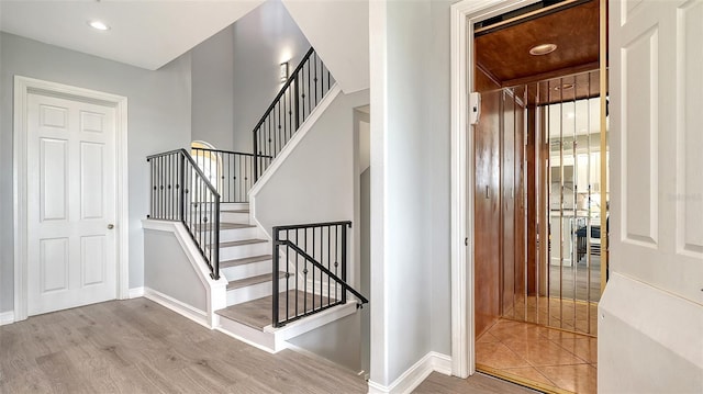 staircase featuring wood-type flooring