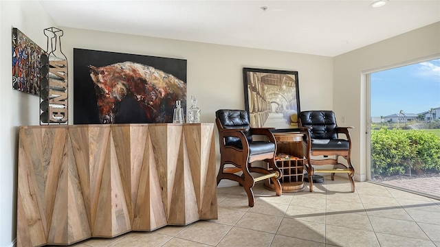 living area with plenty of natural light and light tile patterned floors