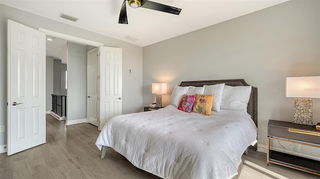 bedroom with ceiling fan and light wood-type flooring