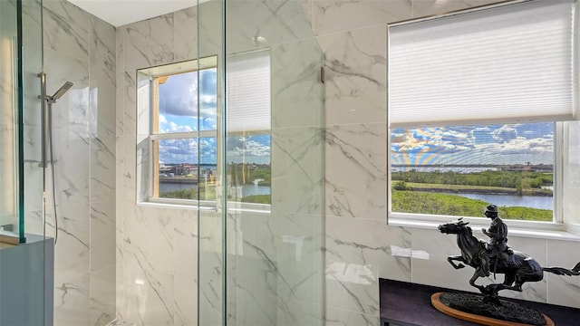 bathroom with a water view and a shower with shower door