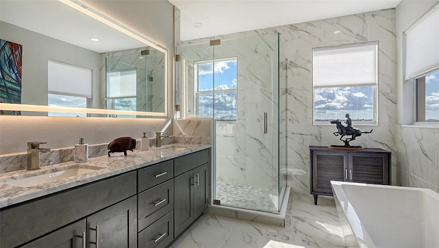 bathroom with separate shower and tub, a wealth of natural light, and vanity