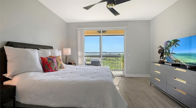 bedroom featuring ceiling fan, light hardwood / wood-style floors, access to outside, and multiple windows