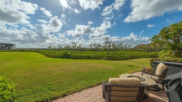 view of yard with a patio area and an outdoor fire pit