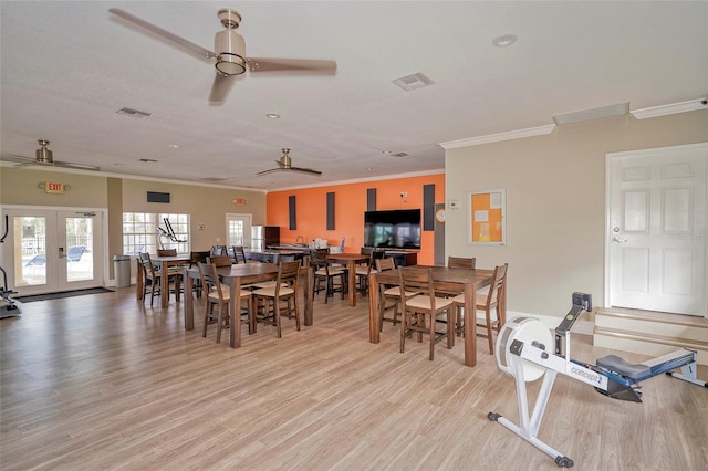 dining space with french doors, light hardwood / wood-style flooring, ceiling fan, and ornamental molding