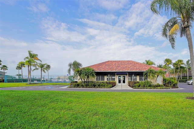 view of front of home with a front yard and french doors