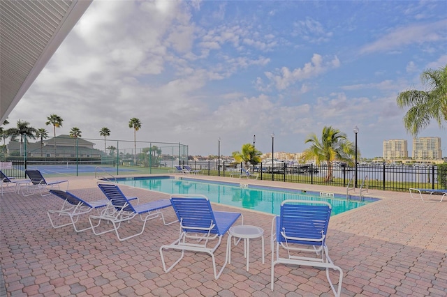 view of pool featuring tennis court