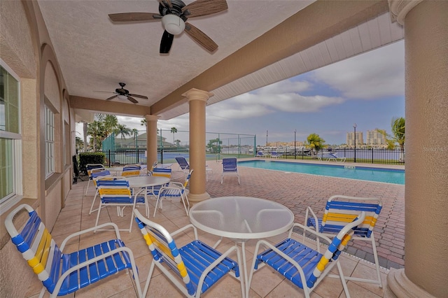 view of patio / terrace with ceiling fan and a community pool