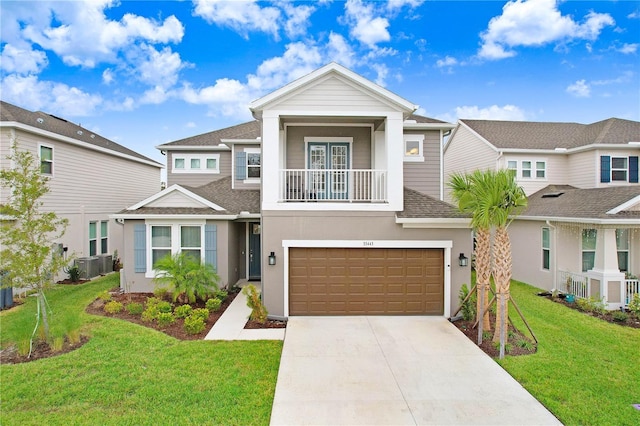 view of front of house with a balcony, central AC unit, a front yard, and a garage