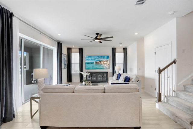 living room with ceiling fan and light hardwood / wood-style flooring