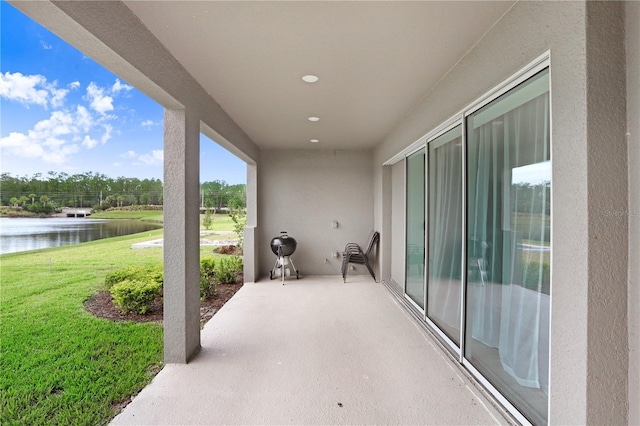 view of patio with a water view